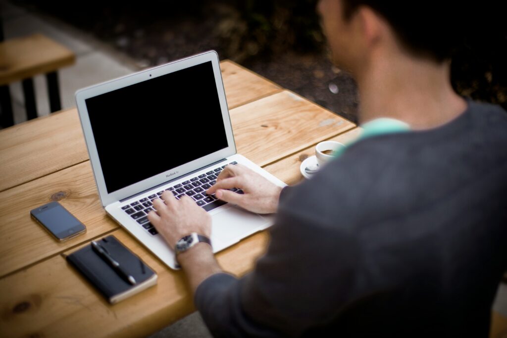 A man typing on a laptop