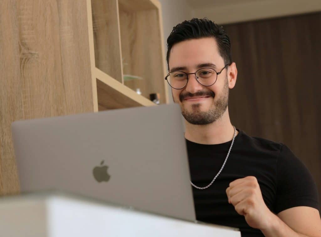 A man sat in front of a laptop